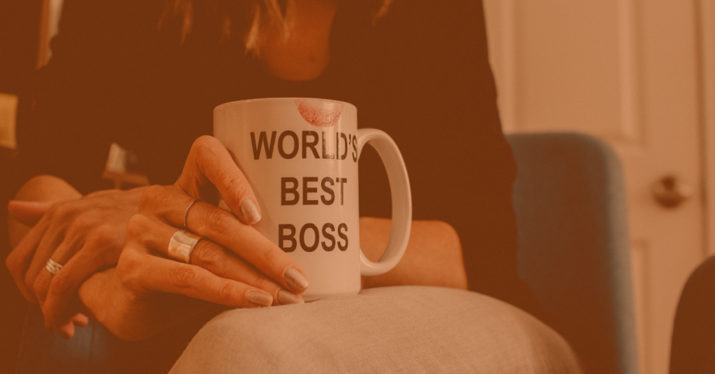 Woman Holding coffee cup that reads "World's Best Boss"